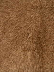 Macro close-up of soft brown faux fur texture and smooth plush material for jackets