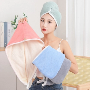 Close-up of soft coral fleece hair towels in pink, blue, gray and green colors
