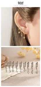 Detailed macro view of various G23 titanium hoop earrings with zircon star pendants