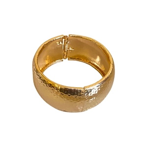 Irregular hammered gold wide metal bangle with elegant polished surface for women