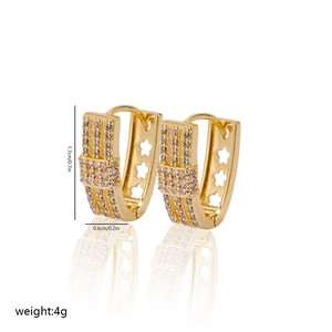 Detail view of 18K gold V-shaped earrings with zircon pavé and floral cut-outs
