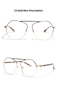 Close-up of gold polygonal metal frame glasses with tortoise shell textured temple tips