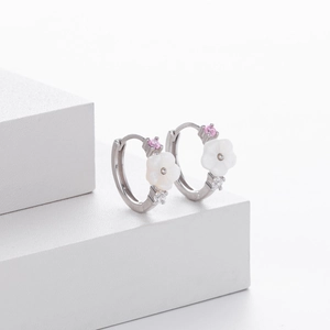 Detailed macro view of S925 sterling silver floral hoop earrings with white petals and zircons