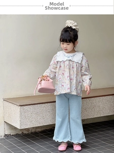 Floral print shirt with oversized lace collar and flared jeans on child model