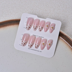 Vue macro d'ongles en amande avec french léopard et détails floraux en relief 3D