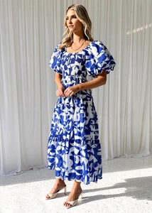 Detailed close-up of blue and white floral dress with puff sleeves and square neckline