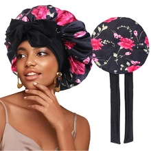 Detail of silk satin sleep bonnet with red floral print and large black bow headband