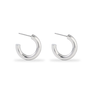 Detailed macro view of polished silver stainless steel thick hoop earrings on white