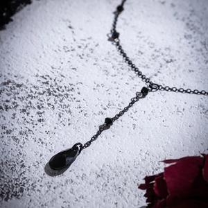 Detail of Gothic choker featuring black teardrop crystal and metallic blood droplets