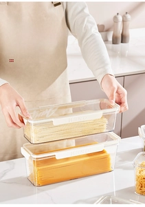 Close-up of airtight plastic noodle container with white secure locking clip for kitchen storage
