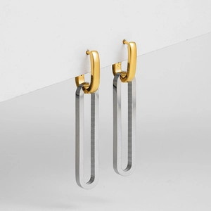 Close-up of gold and silver mixed metal earrings with detachable geometric links