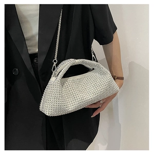 Sparkling silver rhinestone handbag worn with a black blazer for formal evening events