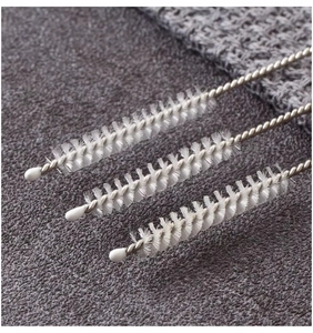 Macro detail of three white nylon straw brushes with stainless steel twisted handles