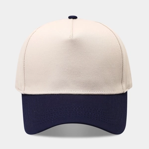 Detail of five-panel baseball cap showing reinforced stitching and navy blue contrast brim
