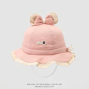 Detail of baby sun hat with pink ears, bow, ruffles, and adjustable chin strap