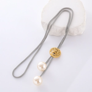 Detail of golden tree of life pendant with white pearls on silver mesh chain necklace