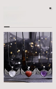 Macro shot of heart-shaped crystal wing pendants in purple, white, and red sandstone