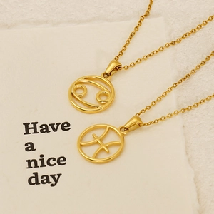 Detailed view of Cancer and Pisces zodiac pendants on gold titanium steel necklaces