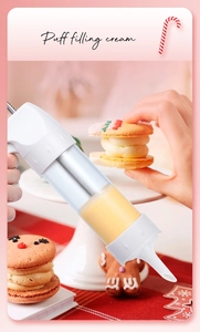 Action shot of clear piping tool filling a Christmas cookie with yellow cream