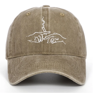 Close-up of white line embroidery on washed khaki vintage cotton baseball cap