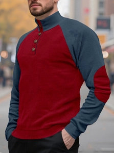 Close-up of men's ribbed knit henley sweater with contrast color block and elbow patches