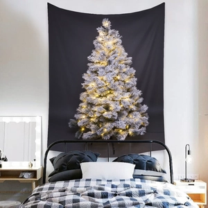 Detail view of black Christmas tapestry with glowing white tree on a bedroom wall