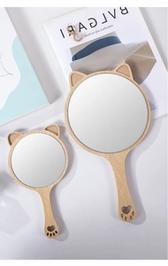 Detail of wooden hand mirrors with cat-ear design and heart cutout handles in two sizes