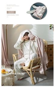 Detail of pink fleece bunny ear hood and heart embroidered gloves on cozy hooded blanket
