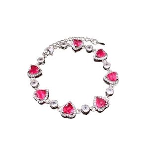 Elegant silver bracelet with heart-shaped red zircons and round white stones
