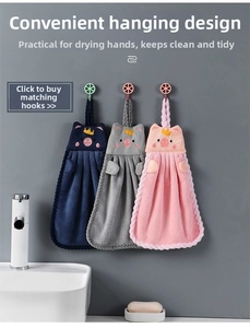 Detailed view of pig-shaped coral fleece hand towels with hanging loops in three colors