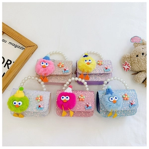 Detail of colorful sequined kids mini handbags with pearl handles and cute chick patches