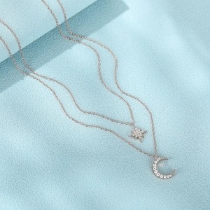 Detail of S925 silver layered necklace with sparkling star and crescent moon pendants