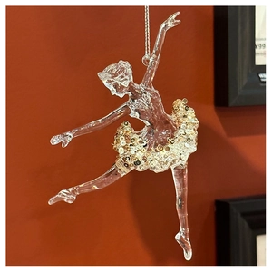 Close-up of clear acrylic ballerina ornament with sparkling gold sequins and silver chain