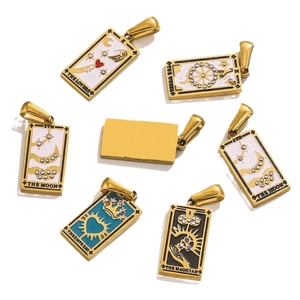 Set of gold tarot card pendants with enamel inlay and zircon accents on white background