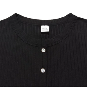 Detail view of ribbed knit texture, V-neck collar and size M label on black Henley shirt