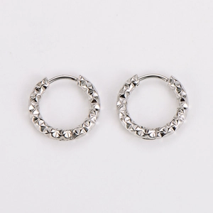 Detailed view of silver stainless steel hoop earrings with textured diamond patterns