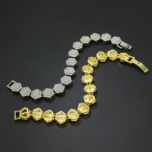 Close-up of geometric hexagon link bracelets in gold and silver finish with crystal pavé