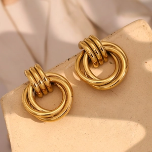 Detail of 18K gold plated multi-layer hoop earrings on a textured stone display