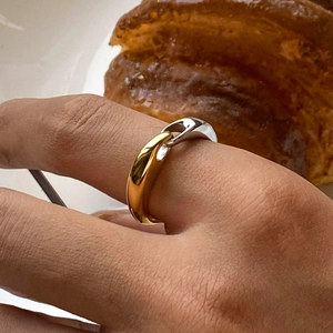Two-tone gold and silver stainless steel link ring shown on model with French aesthetic