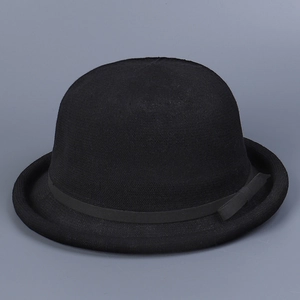 Close-up of vintage black knit bowler hat with rolled brim and delicate ribbon bow detail