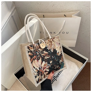 Close-up of linen tote bag with floral pattern in a white gift box with rope handles