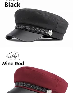 Detail of wool baker boy hats with leather brims in black and burgundy with metal buttons