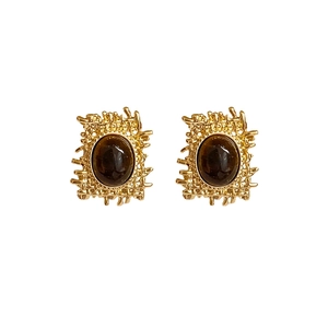 Vintage gold stud earrings with oval tiger eye stone in a textured nest design on white
