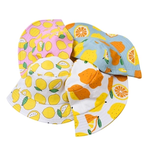 Close-up of lightweight kids bucket hats with vibrant lemon and citrus fruit prints