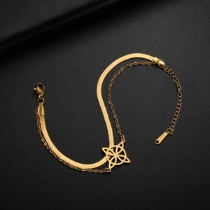Close-up of golden double-layered stainless steel bracelet with Celtic knot floral pendant