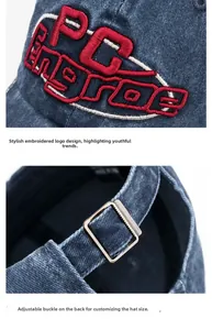 Detail of 3D embroidery and adjustable metal buckle on distressed denim baseball cap