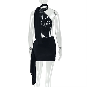 Detail of black backless halter top and bodycon skirt set on transparent mannequin