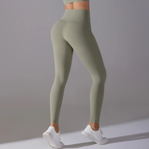 Detail view of seamless high-waisted sage green yoga pants featuring body-shaping compression