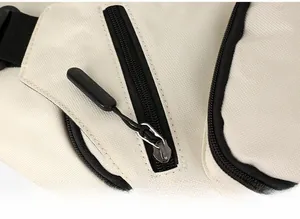 Close-up detail of smooth zipper and black puller on beige oxford fabric bag
