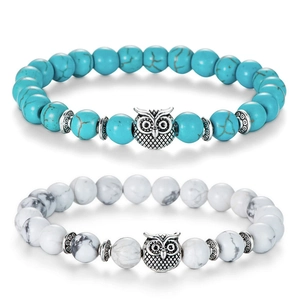 Detail of owl charm beaded bracelets with turquoise and white marble stone textures